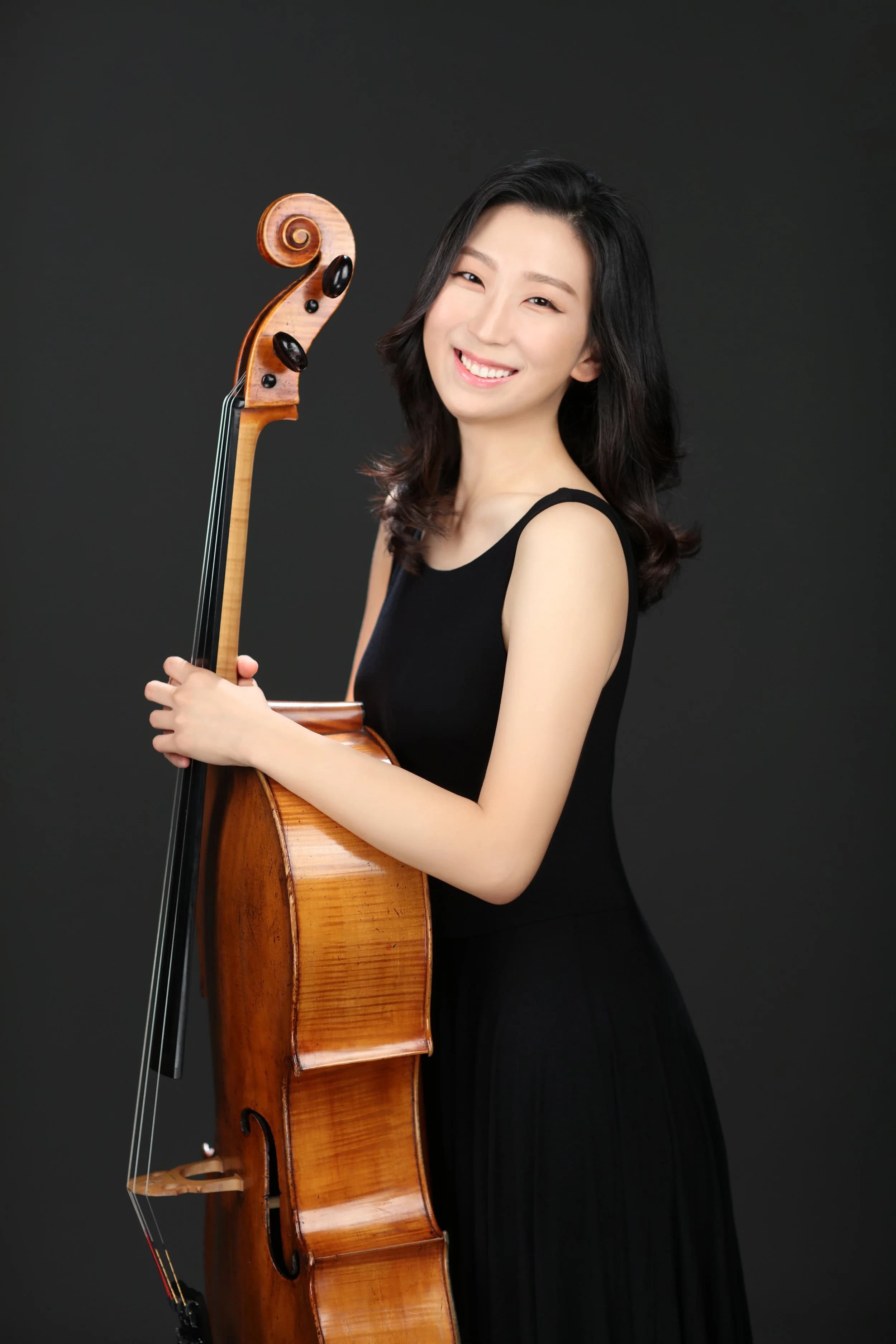 Elizabeth Lee seated with her cello, editorial portrait